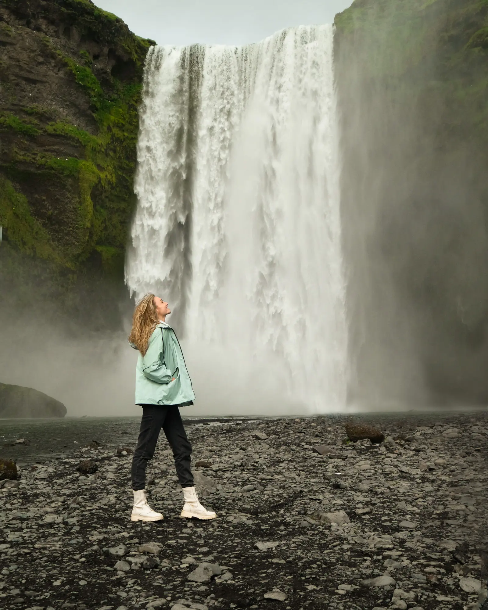travel blogger at Skogafoss waterfall in Iceland near Vik