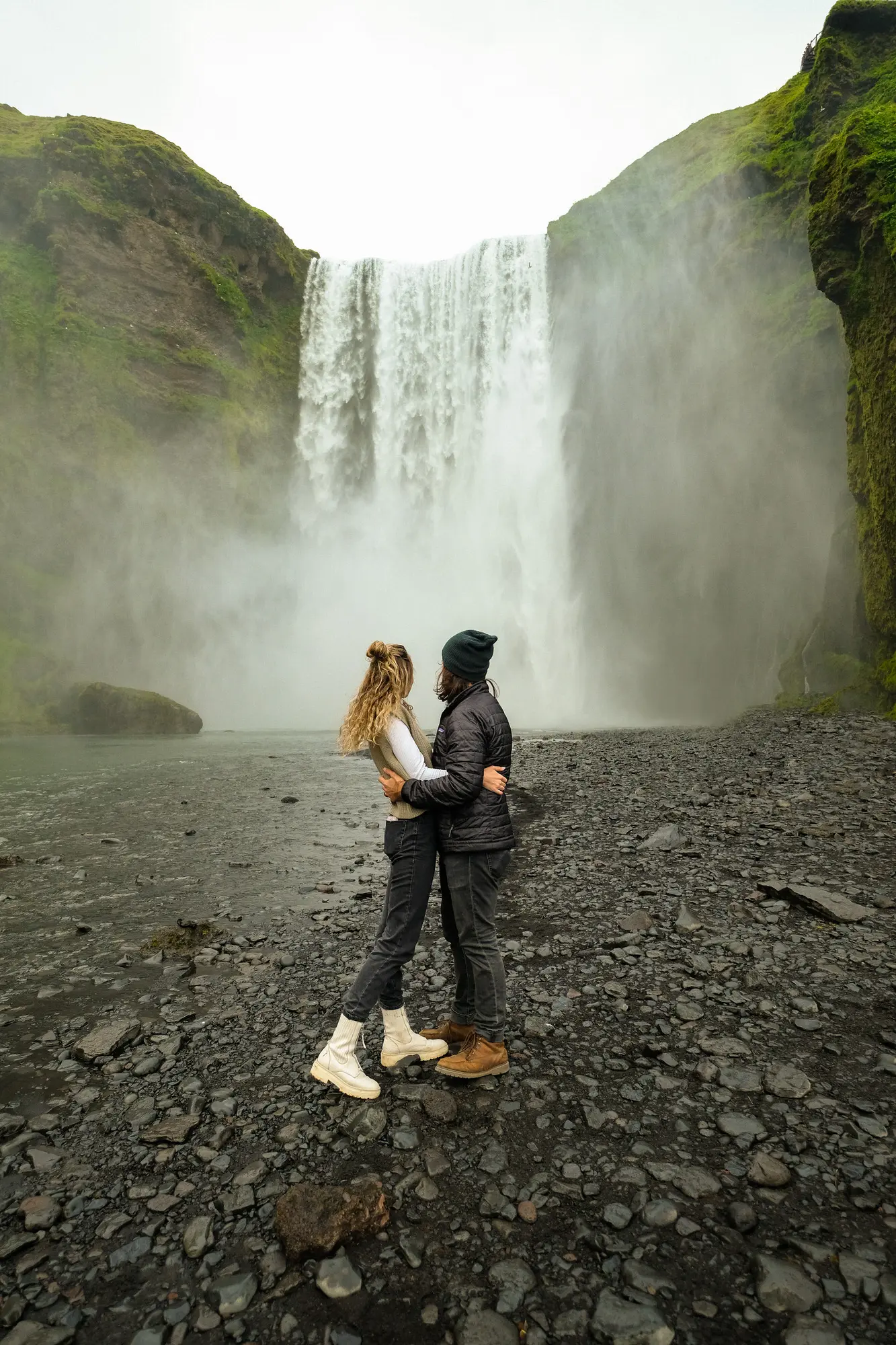 couple from Utah in front of Skogafoss waterfall near Vik Iceland